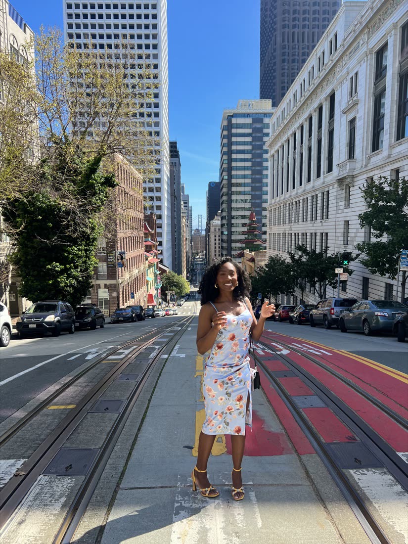 Destiny standing on California Street in San Francisco on a bright morning